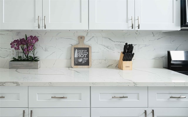 details with white cabinets and decorative backsplash