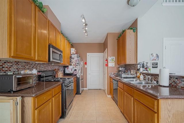 kitchen with black appliances, light tile patterned floors, backsplash, and a sink