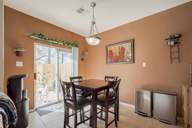 dining area with light tile patterned flooring, visible vents, and baseboards