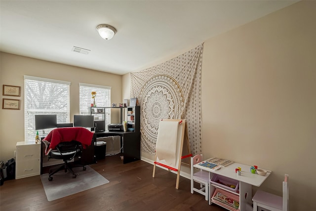 office area featuring visible vents and dark wood-type flooring