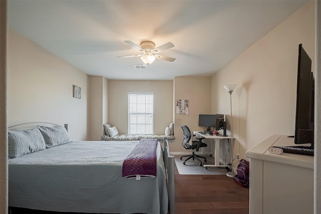 bedroom featuring wood finished floors, visible vents, and a ceiling fan