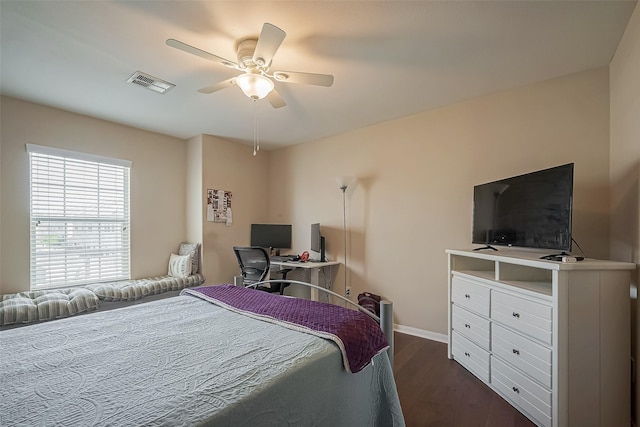 bedroom featuring baseboards, dark wood-style flooring, visible vents, and a ceiling fan