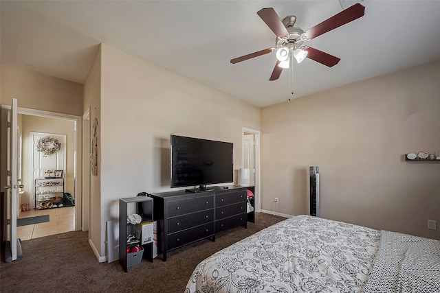 carpeted bedroom with a ceiling fan and baseboards