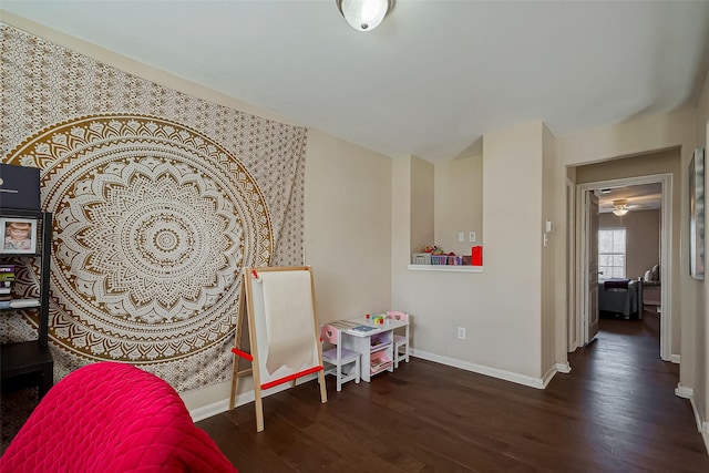 playroom featuring baseboards and wood finished floors