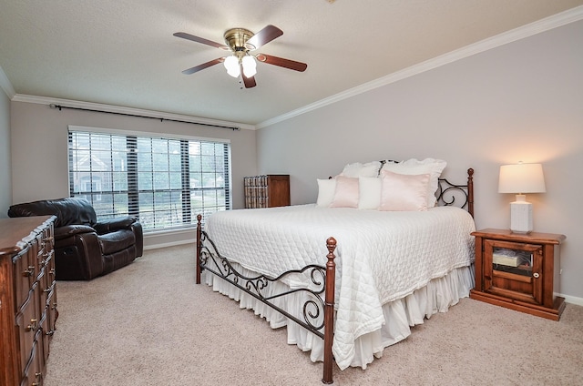 bedroom featuring light carpet, ceiling fan, baseboards, and crown molding