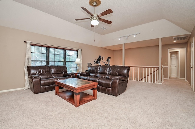 living area featuring light carpet, baseboards, visible vents, a ceiling fan, and a textured ceiling