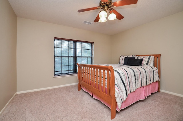 bedroom with light colored carpet, visible vents, and baseboards