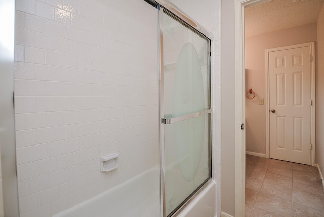 full bathroom with enclosed tub / shower combo, baseboards, and tile patterned floors