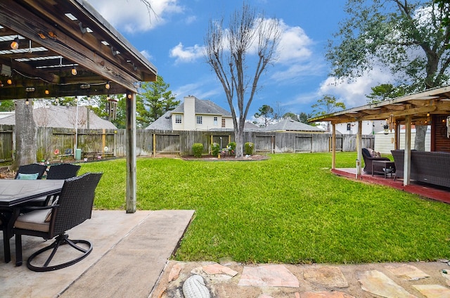 view of yard with a patio, outdoor dining area, and a fenced backyard