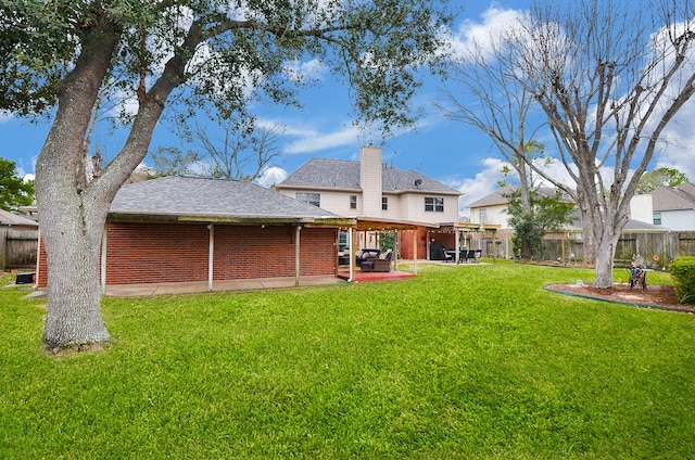 back of property featuring a patio area, a fenced backyard, a lawn, and a chimney