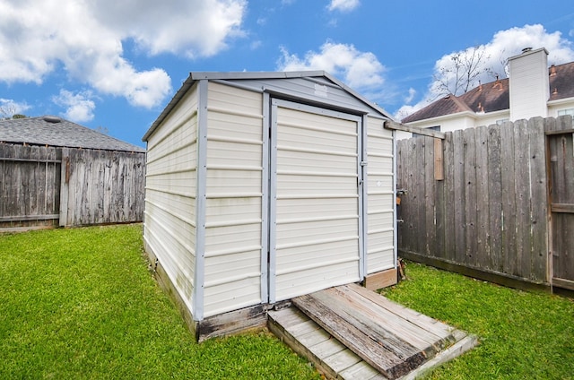 view of shed featuring a fenced backyard