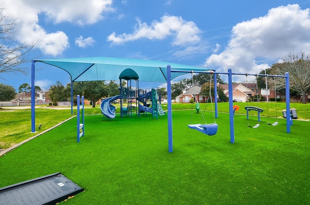 community jungle gym featuring a yard