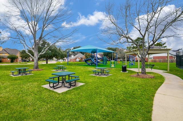 surrounding community with fence, a lawn, and playground community