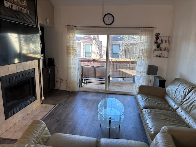 living room featuring wood finished floors and a tile fireplace