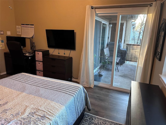 bedroom with dark wood-style floors and access to exterior