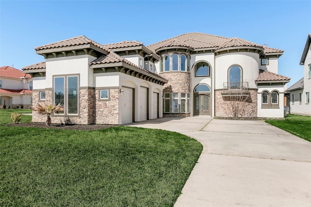 mediterranean / spanish-style home featuring concrete driveway, a front lawn, stone siding, and stucco siding