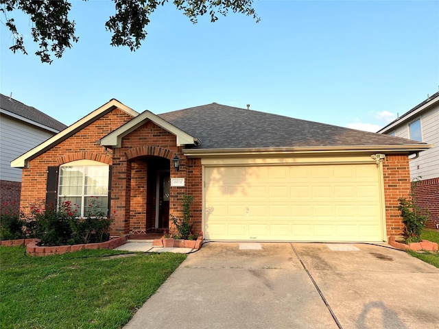 ranch-style home featuring an attached garage, concrete driveway, brick siding, and a shingled roof