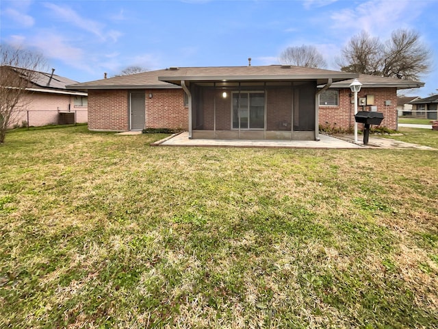 back of property with a lawn, a patio, fence, central AC, and brick siding