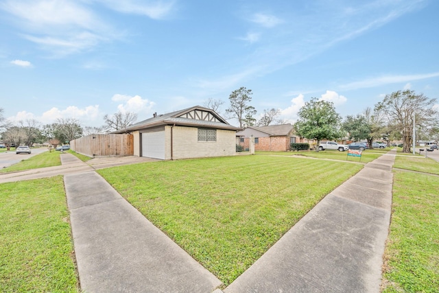 exterior space with concrete driveway, brick siding, a yard, and an attached garage