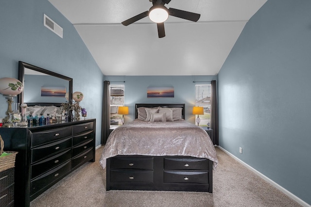 bedroom featuring light carpet, baseboards, visible vents, and vaulted ceiling