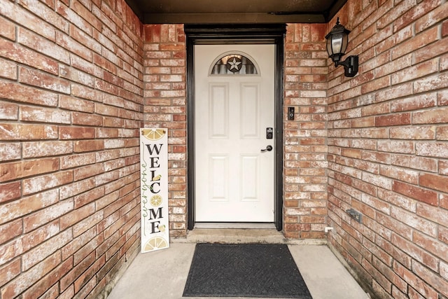 view of exterior entry with brick siding