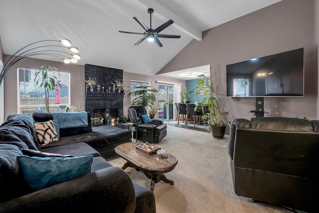 carpeted living area featuring a ceiling fan, a fireplace, beamed ceiling, and high vaulted ceiling