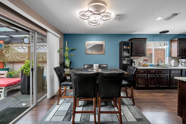 dining room featuring dark wood-style floors and visible vents