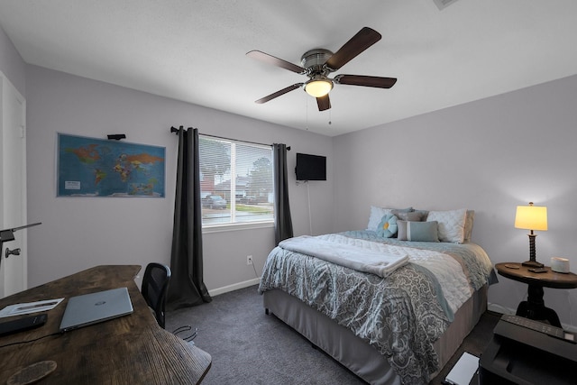 bedroom with baseboards, dark carpet, and a ceiling fan