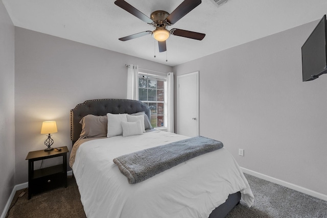 bedroom featuring ceiling fan, dark colored carpet, and baseboards