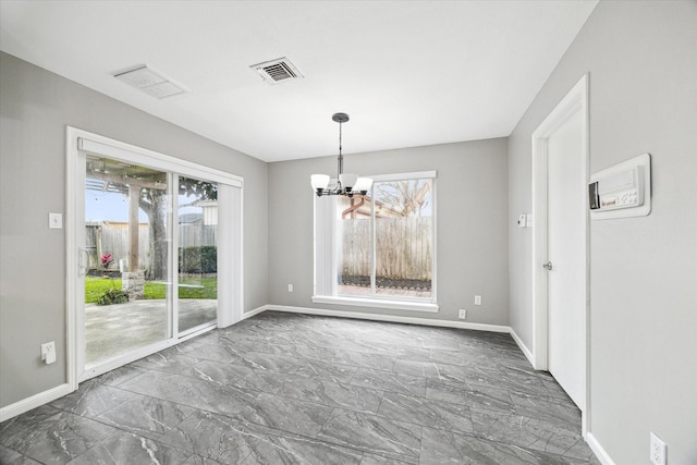 unfurnished dining area with marble finish floor, baseboards, visible vents, and a notable chandelier