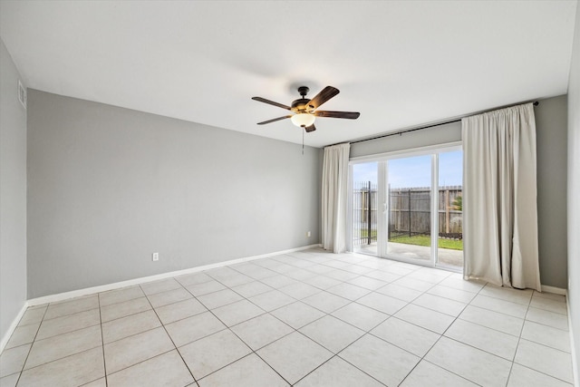 spare room featuring ceiling fan and baseboards