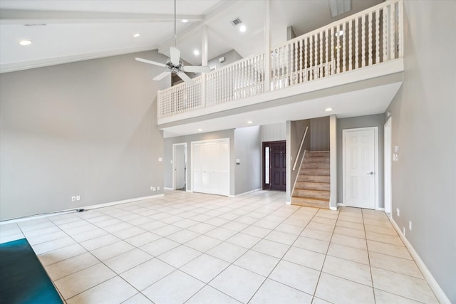 unfurnished living room with baseboards, visible vents, ceiling fan, stairway, and beam ceiling