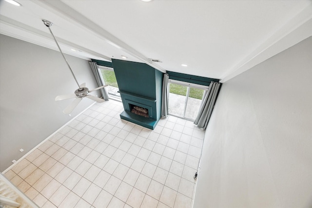 unfurnished living room featuring a large fireplace, light tile patterned floors, and baseboards