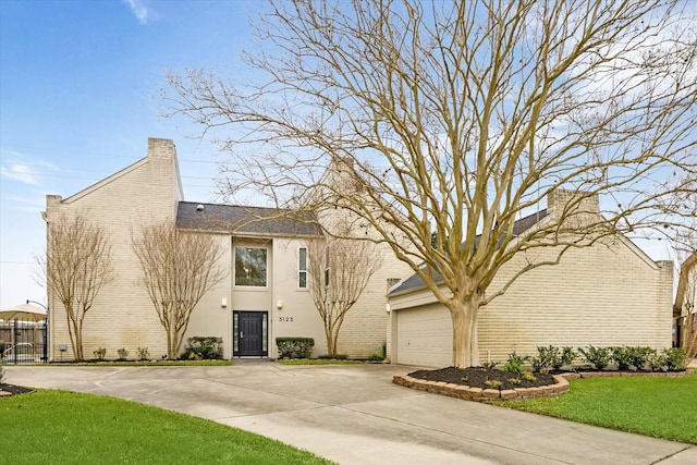 view of property featuring a garage, driveway, and fence