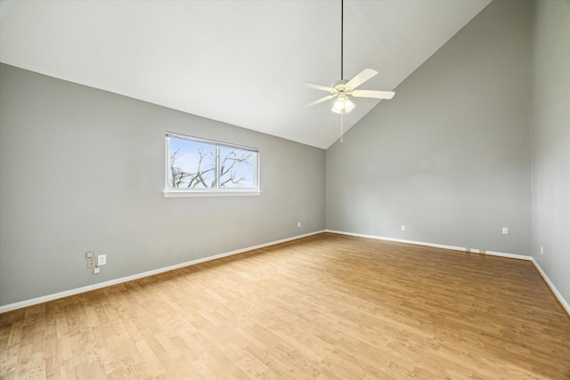 spare room with high vaulted ceiling, baseboards, ceiling fan, and light wood finished floors