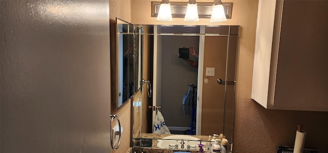 bathroom featuring a textured wall