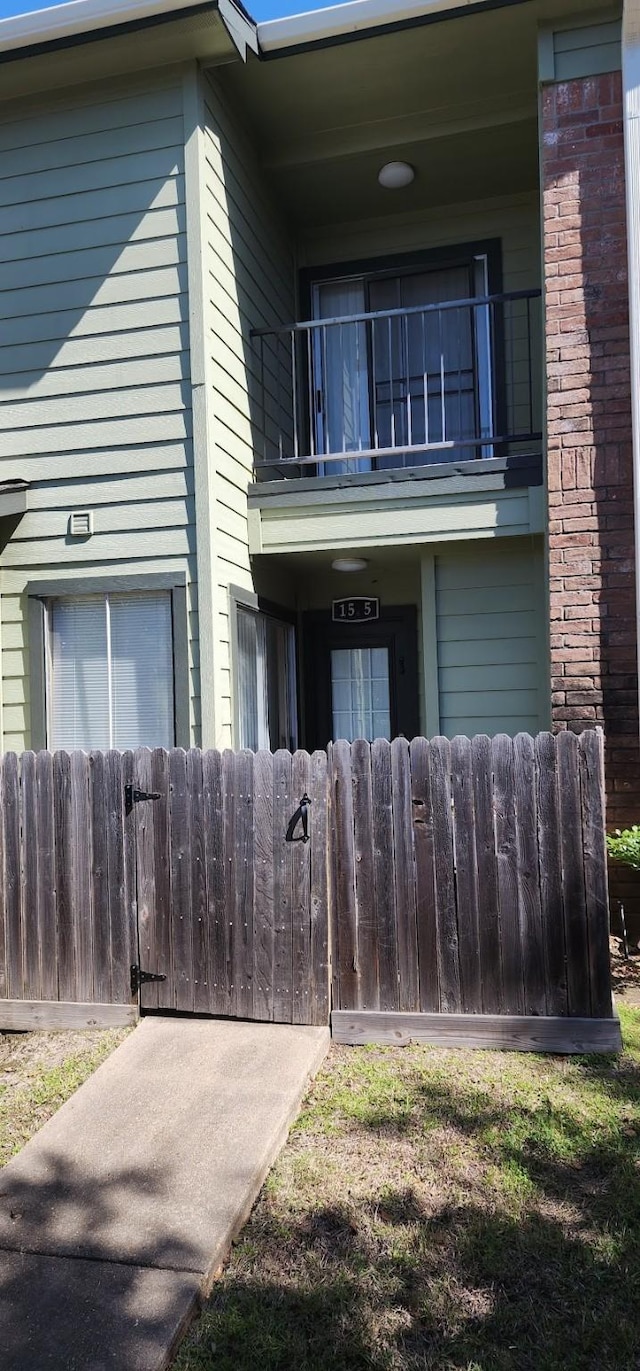 exterior space with fence and a balcony