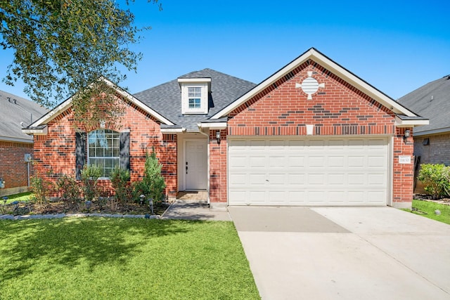 view of front facade with an attached garage, brick siding, driveway, roof with shingles, and a front yard