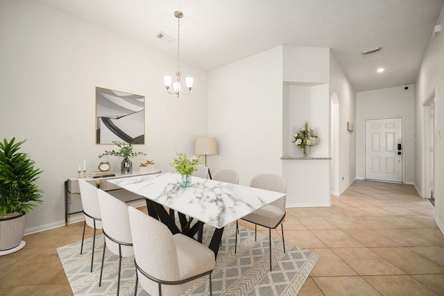 dining space featuring a chandelier, visible vents, baseboards, and light tile patterned floors