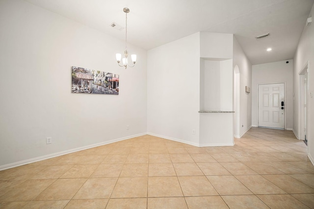 unfurnished room with a chandelier, light tile patterned flooring, visible vents, and baseboards