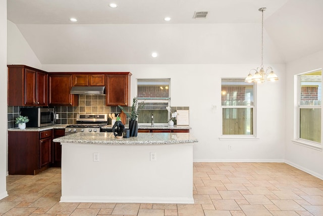 kitchen featuring under cabinet range hood, visible vents, vaulted ceiling, appliances with stainless steel finishes, and decorative backsplash