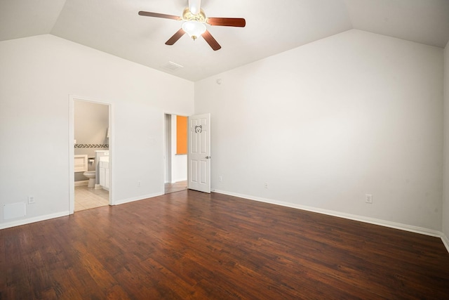 unfurnished bedroom with baseboards, visible vents, connected bathroom, lofted ceiling, and wood finished floors