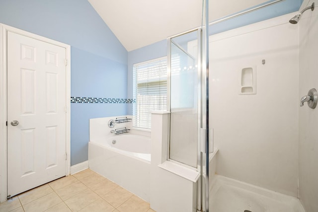 bathroom featuring a garden tub, a shower stall, vaulted ceiling, and tile patterned floors