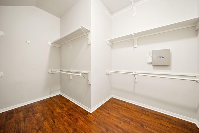 spacious closet with lofted ceiling and wood finished floors