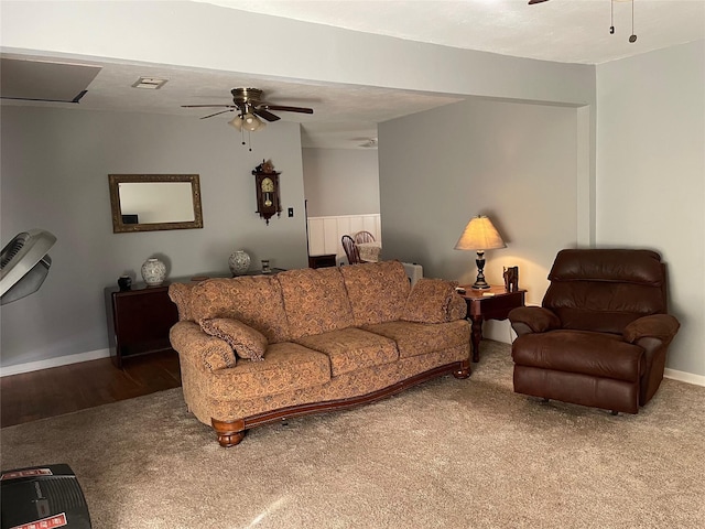 carpeted living room with visible vents, a ceiling fan, and baseboards