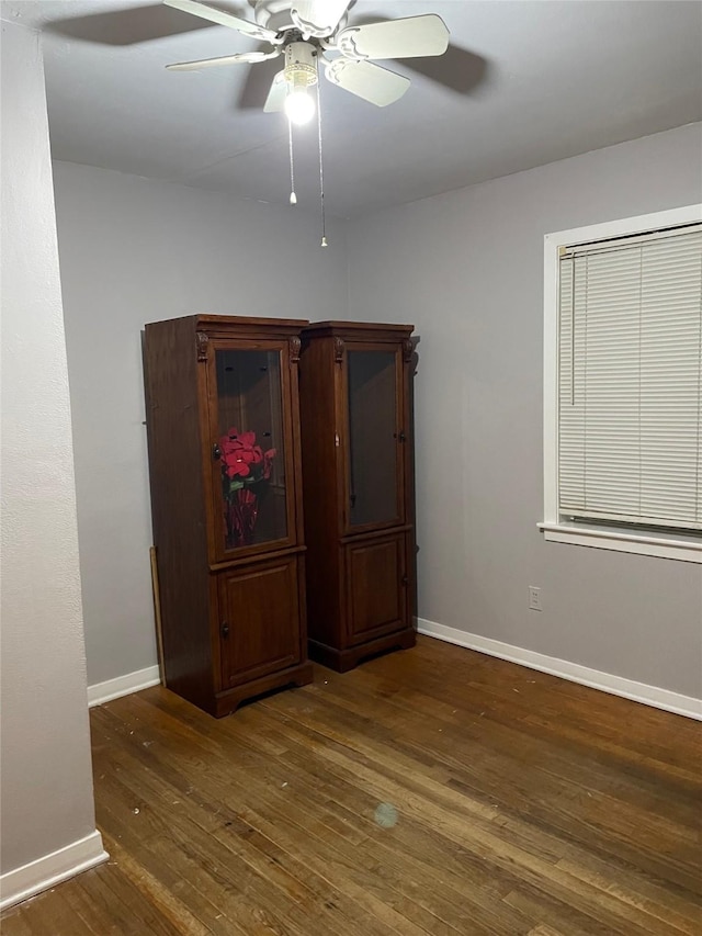 unfurnished room featuring ceiling fan, baseboards, and hardwood / wood-style flooring