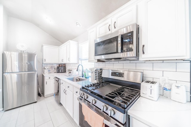 kitchen featuring light countertops, appliances with stainless steel finishes, a sink, and white cabinets