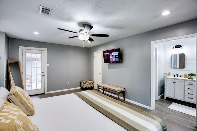 bedroom with visible vents, dark wood finished floors, and baseboards