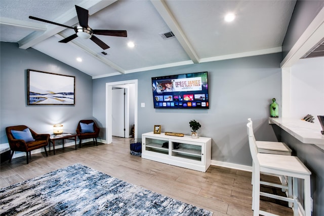 interior space featuring light wood-type flooring, vaulted ceiling with beams, baseboards, and visible vents