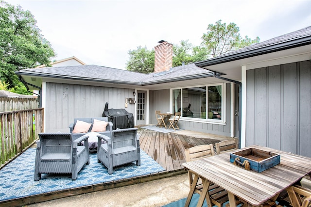 deck with an outdoor hangout area, fence, grilling area, and outdoor dining space